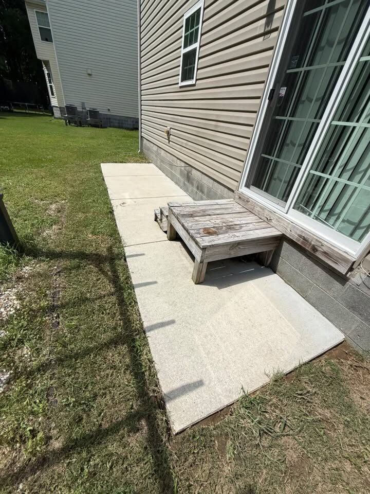 The same concrete pad cleaned to an even light finish