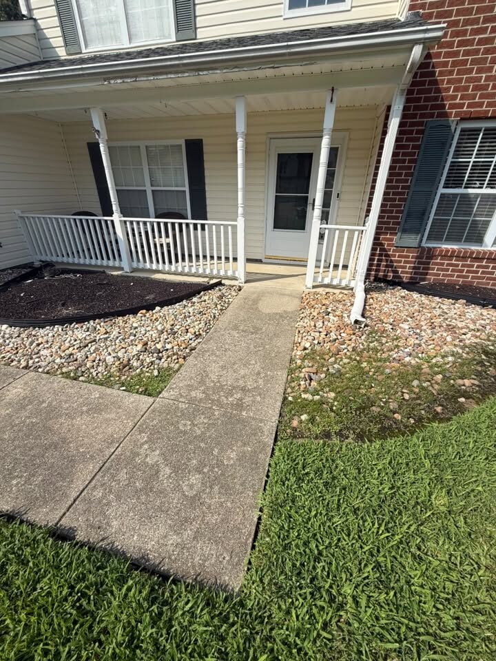 Front walkway of a home, the concrete stained grey and green before cleaning